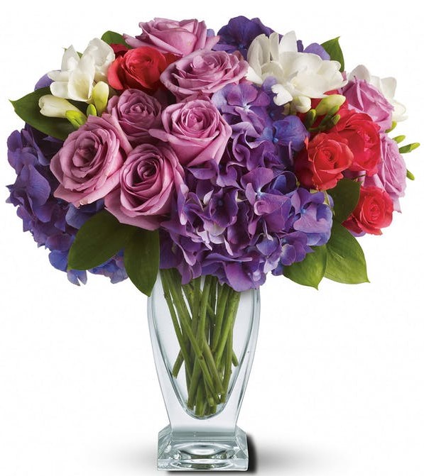 A rhapsody of beauty is on stunning display in this arrangement. Gorgeous blossoms are beautifully arranged and delivered in a divine Couture Vase.