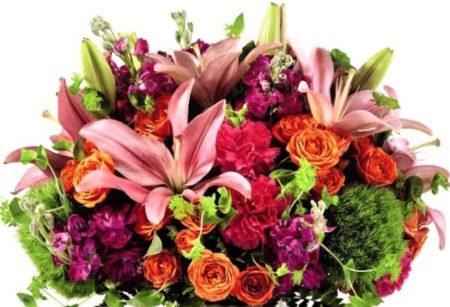 An array of sweet pink lilies, orange spray roses and green trick dianthus fill an elegant gray ceramic vase with geometric detailing. From its stunning detail to vibrant hues, this bouquet is the perfect just because gift to share with someone special!