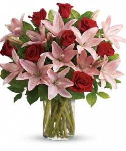 Turn an ordinary day into an enchanting daydream by sending her this magical bouquet! This stunning bouquet of rich red roses and magnificent pink lilies pampers her senses, refreshes her spirit and shows her how much you really care.