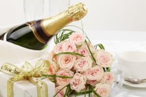 Pink roses and bottle of champagne