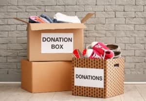 Brown donation boxes with shoes and clothes